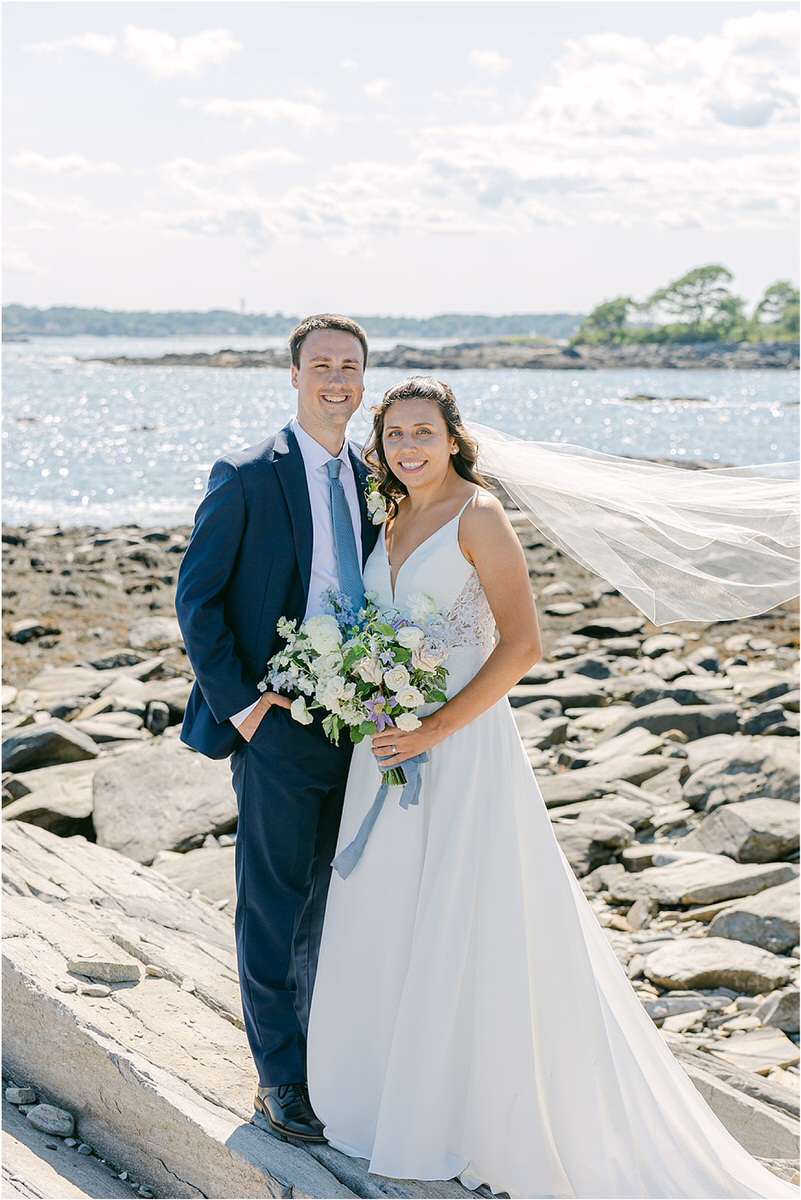 Couple stand close together near water before celebration at at Portland's Ocean Gateway
