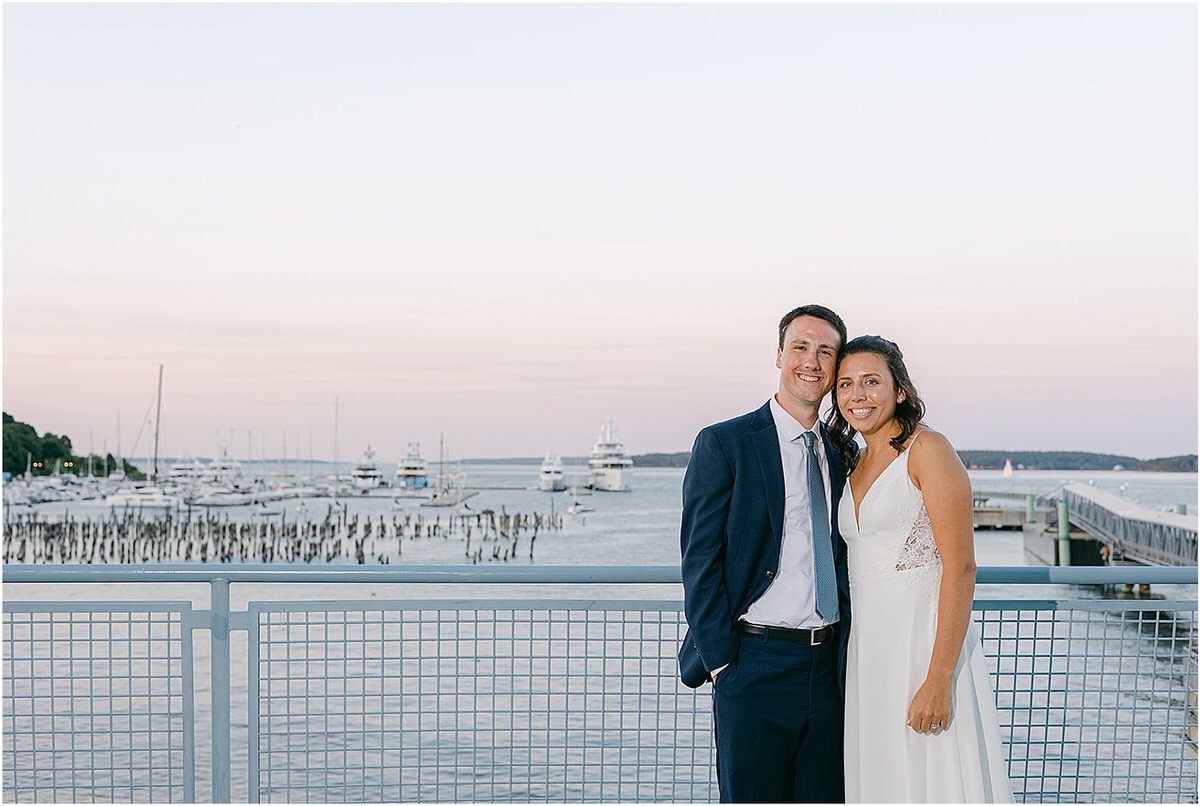 Bride and groom stand on balcony for Rachel Campbell Photography