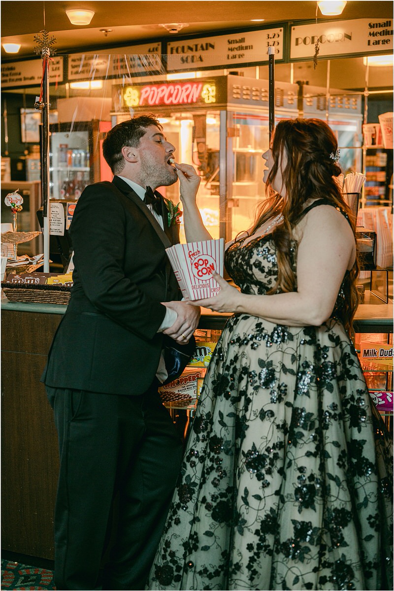 Bride and groom celebrate with popcorn at The Strand Theatre