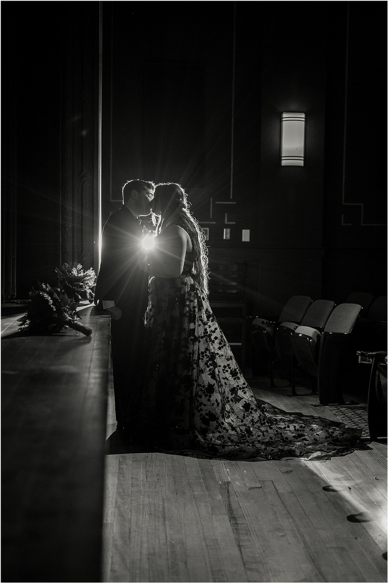 Couple stand together in front of a light at The Strand Theatre