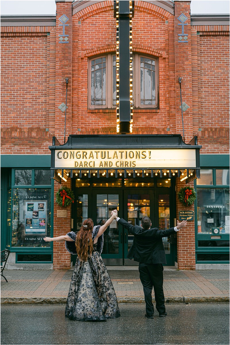 Couple celebrate together in front of the theatre Rachel Campbell Photography