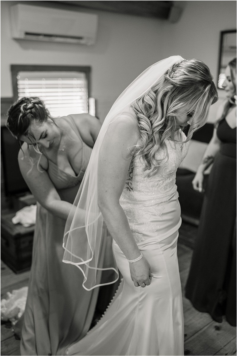 Bride gets into wedding gown for Rachel Campbell Photography