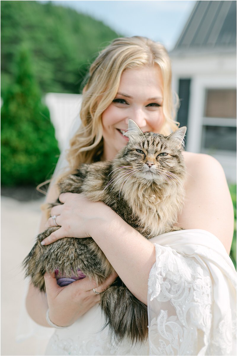Bride smiles with cat for Rachel Campbell Photography