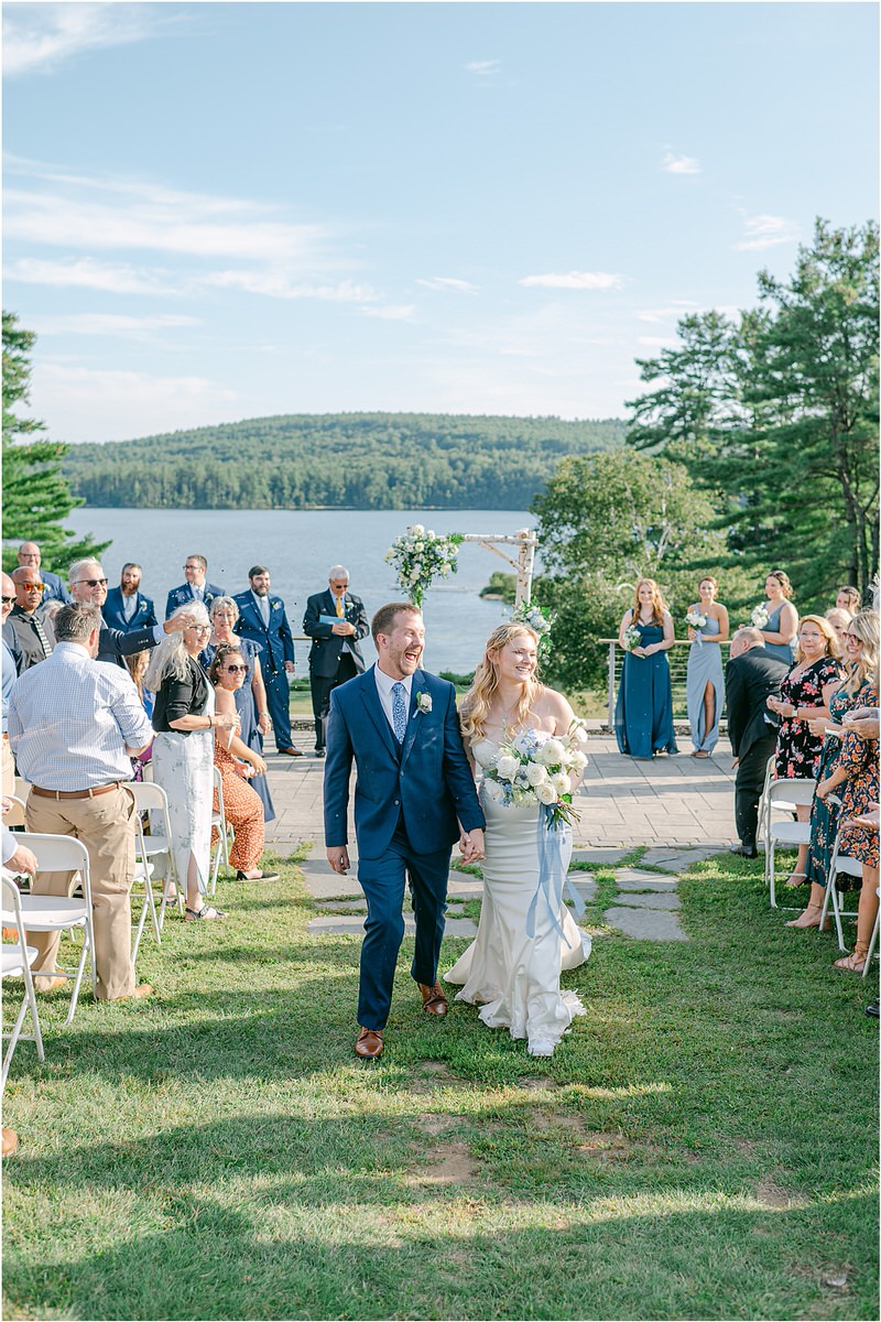 Bride and groom hold hands together at Bear Mountain Inn