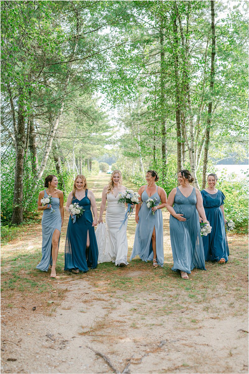 Bride walks with bridesmaids at Bear Mountain Inn