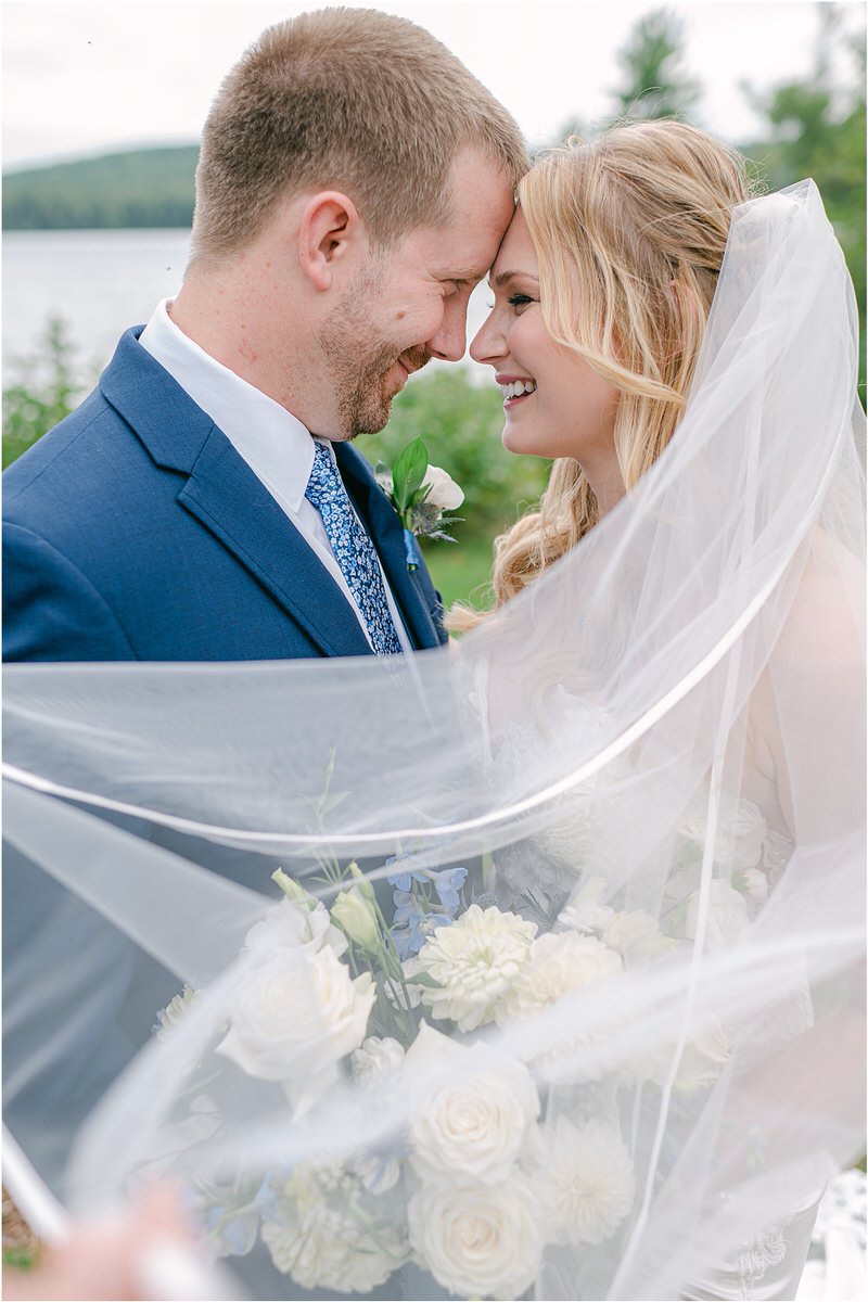 Bride and groom smile at one another at Bear Mountain Inn