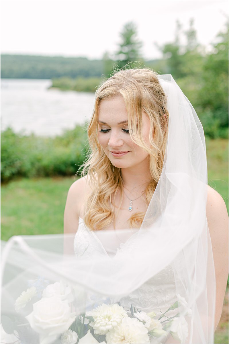 Bride smiles and looks down at Bear Mountain Inn