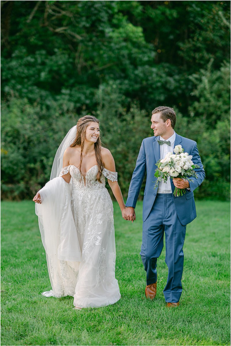 Bride and groom walk hand in hand together for Rachel Campbell Photography