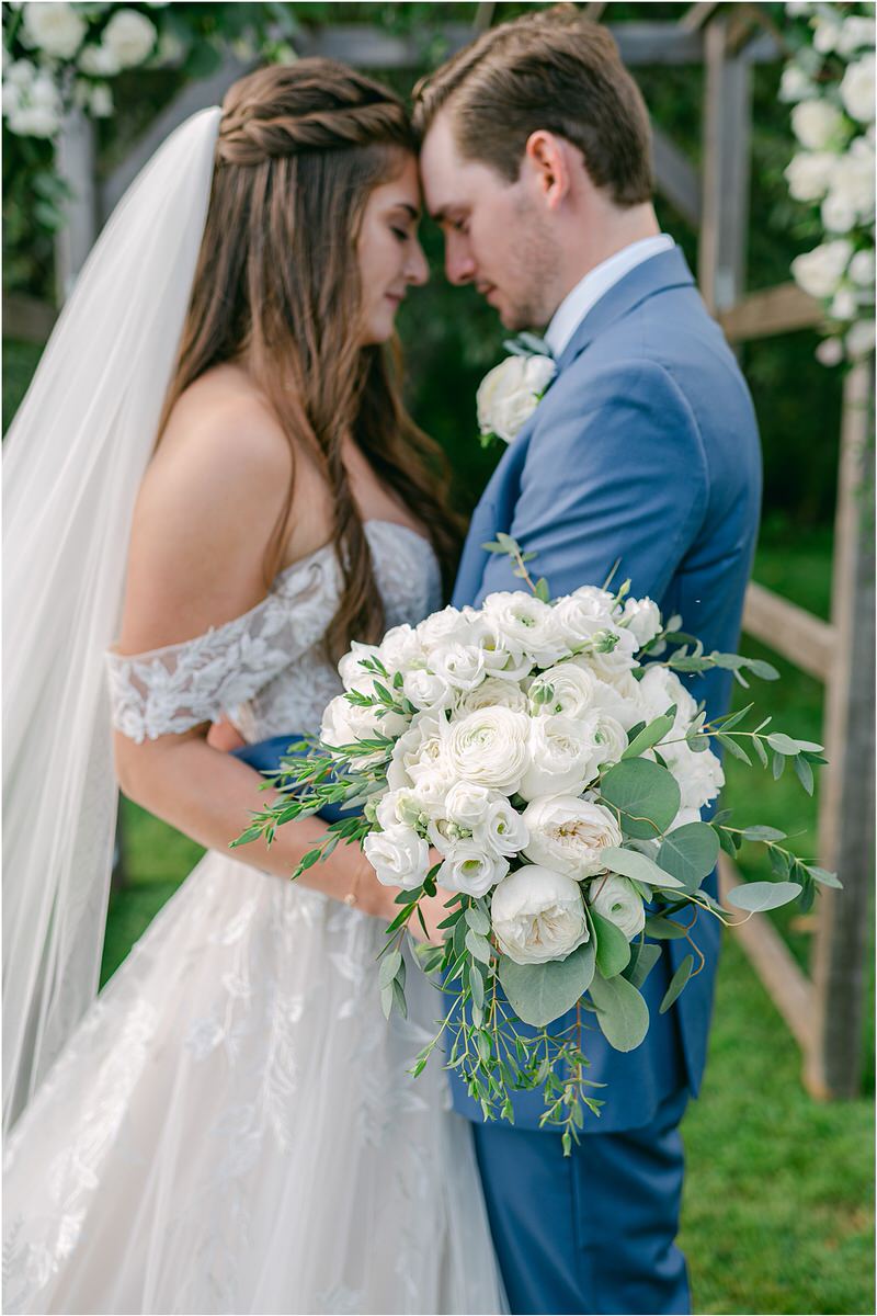 Bride and groom cuddle in close together for Rachel Campbell Photography