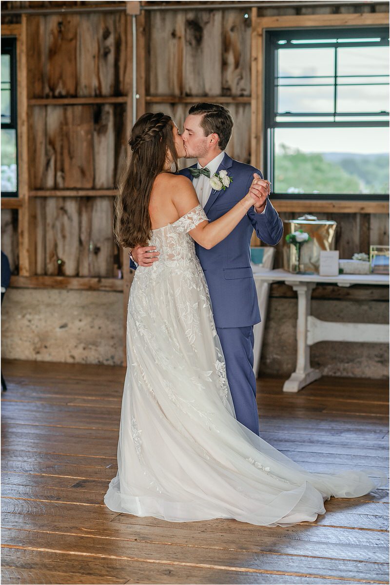 Groom kisses bride at Harmony Hill Farm