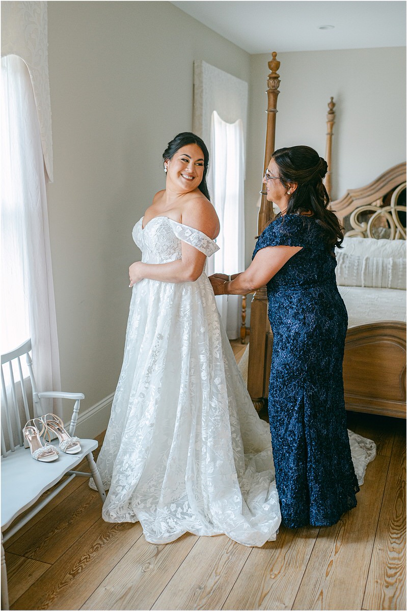 Mother of the bride smiles with her daughter at The Red Barn at Outlook Farm