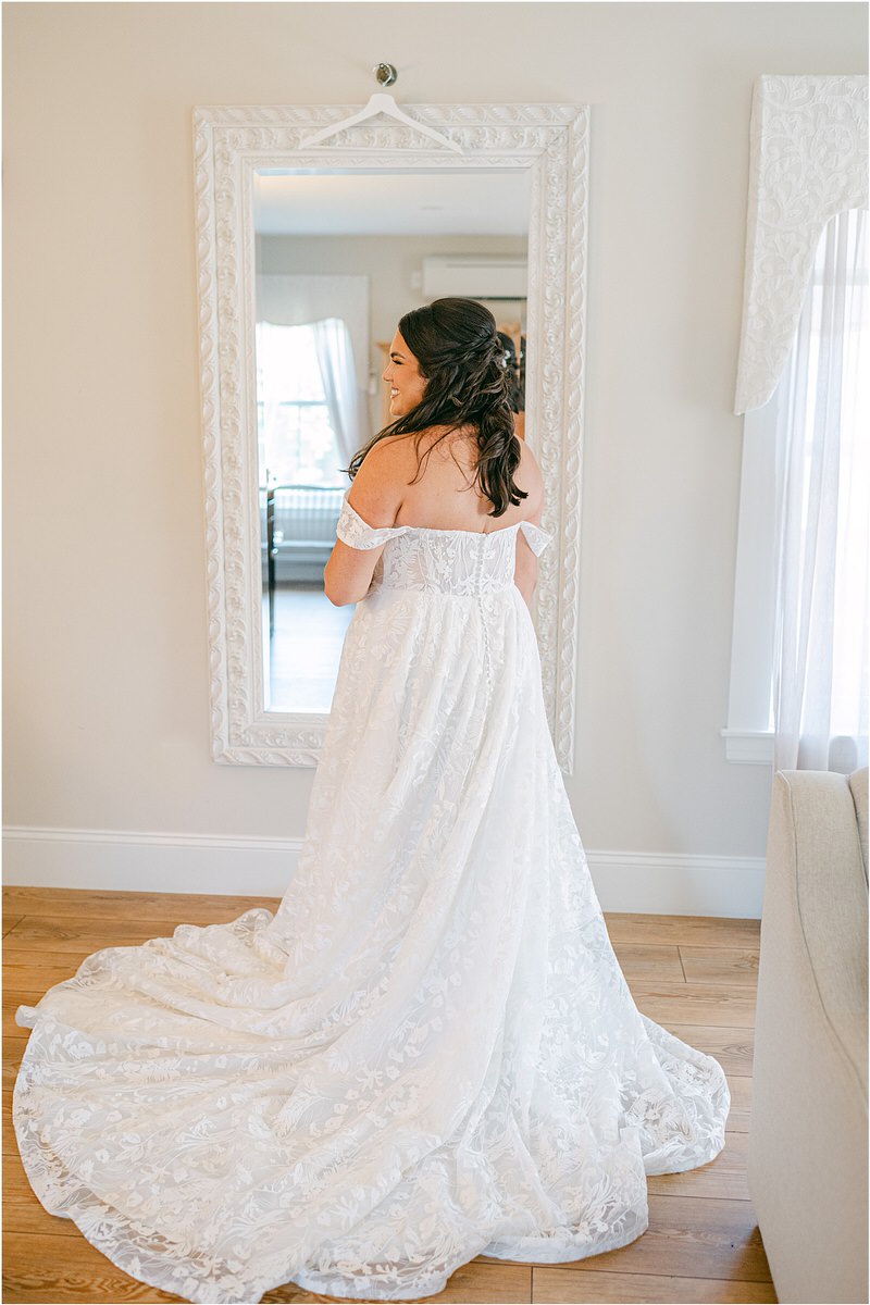 Bride smile in her bridal gown at The Red Barn at Outlook Farm