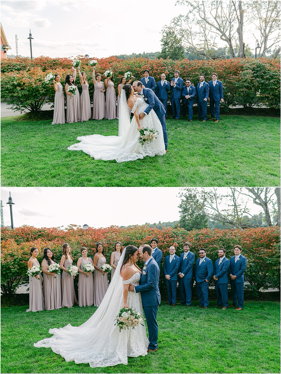 Husband and wife share a kiss stnanding in front of wedding party at The Red Barn at Outlook Farm