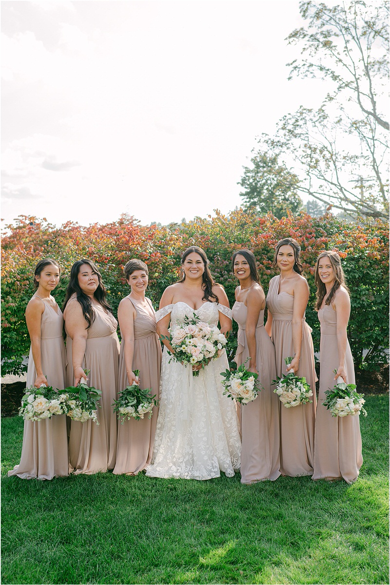 Bride smiles big surrounded by her bridesmaids for Rachel Campbell Photography