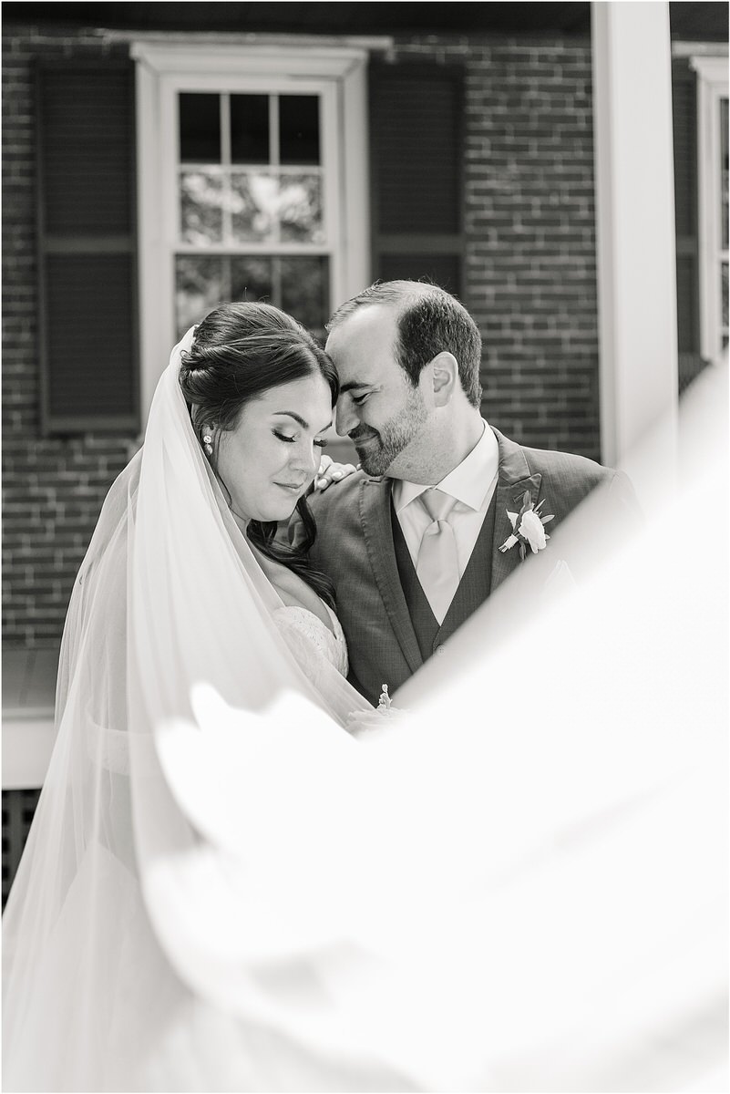 Bride and groom cuddle in close together for Rachel Campbell Photography
