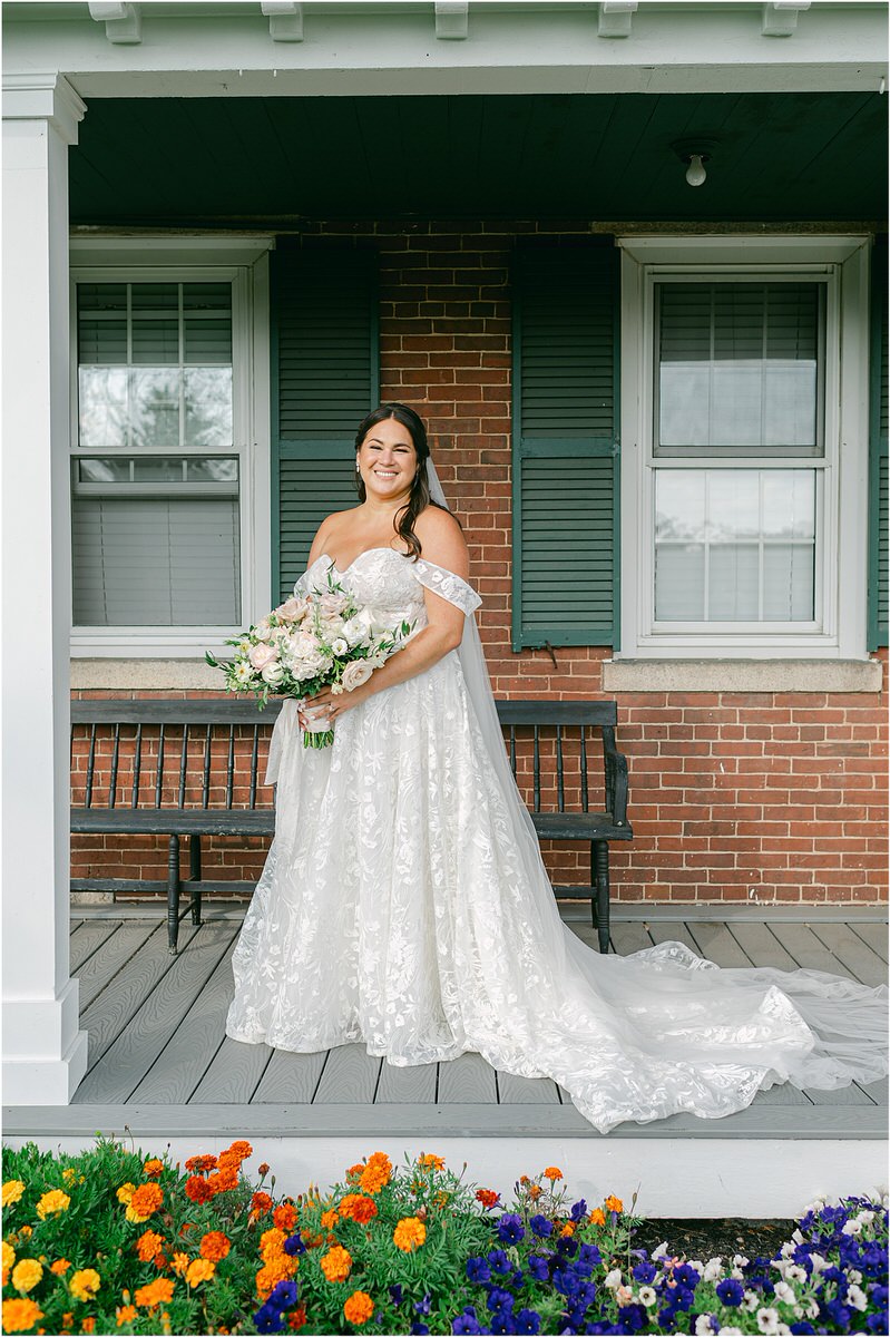 Bride smiles big holding her bouquet for Rachel Campbell Photography