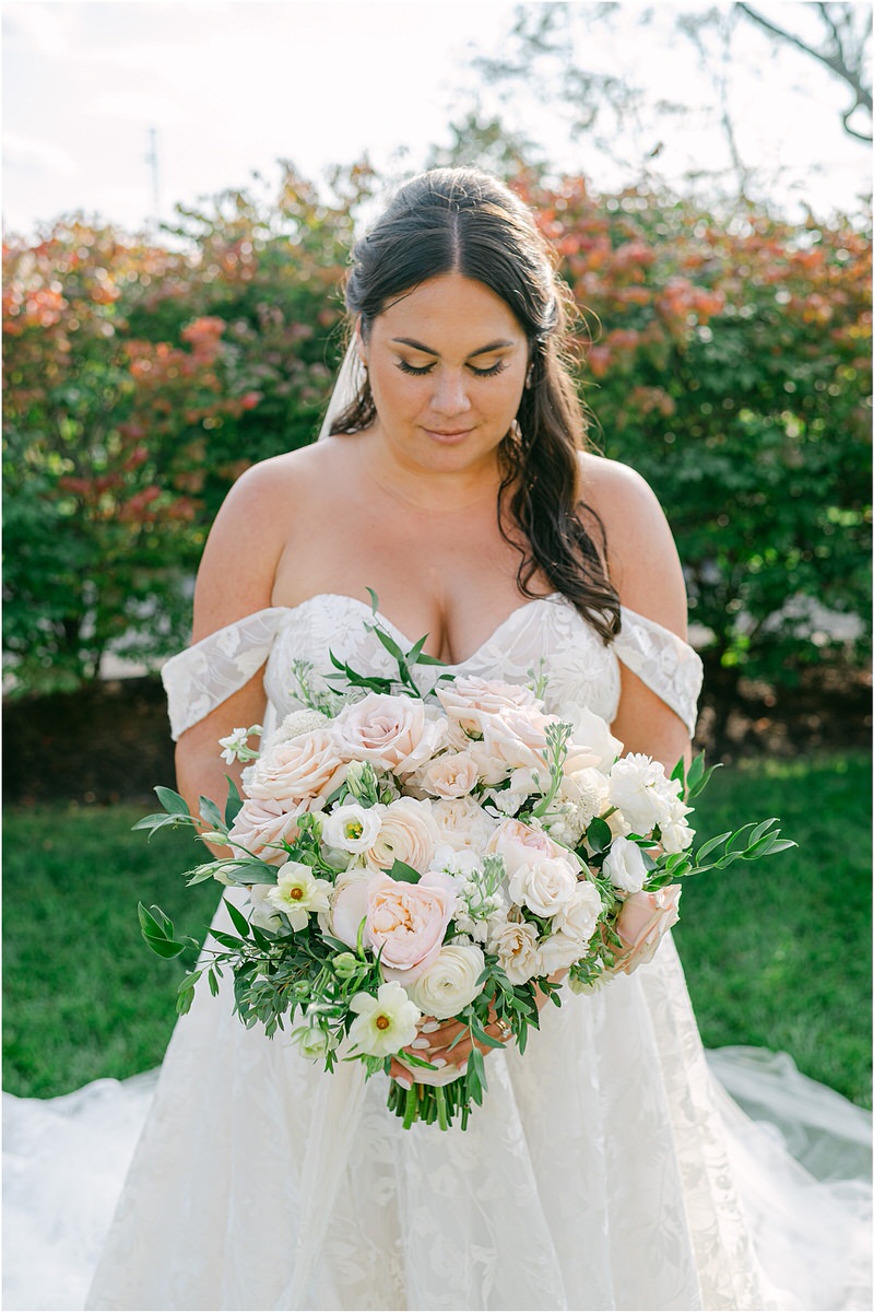 Bride looks down at bouquet for Rachel Campbell Photography